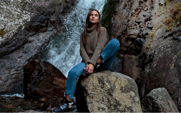 Woman in front of waterfall